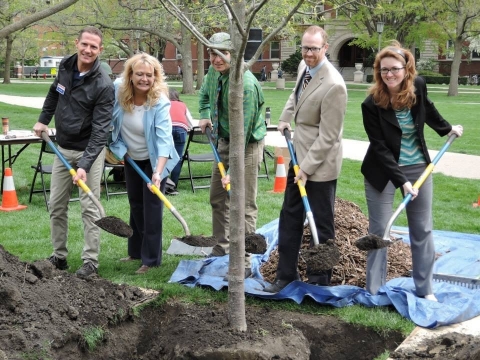 tree committee adding soil to Arbor Day 2015 tree