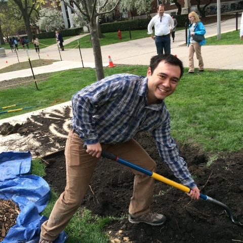 student adding soil to Arbor Day 2015 tree
