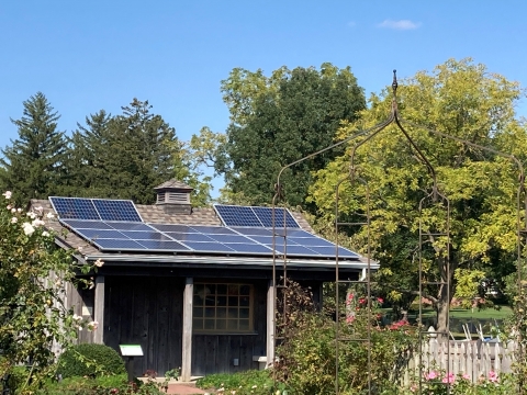 solar panels on a shed in a garden