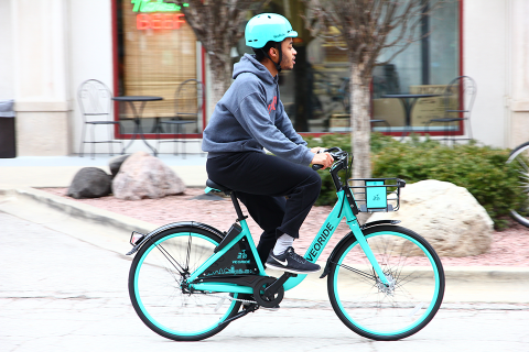 Rider with helmet on a VeoRide bicycle