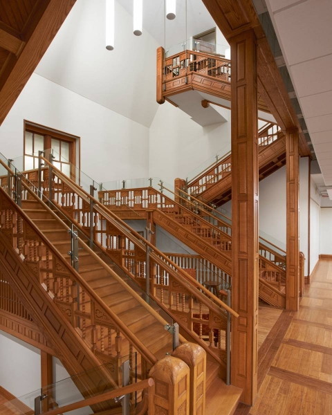 A three-flight staircase built with reused wood that was removed from the building for the renovation.