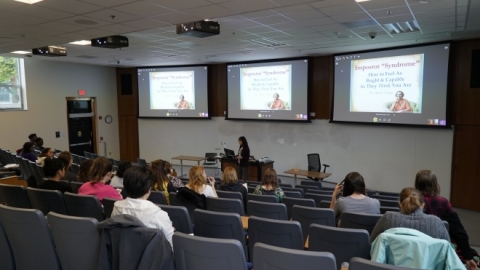 Students attending a lecture in a large auditorium.