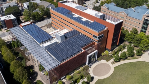 Aerial shot of the building showing the roof covered in solar panels.