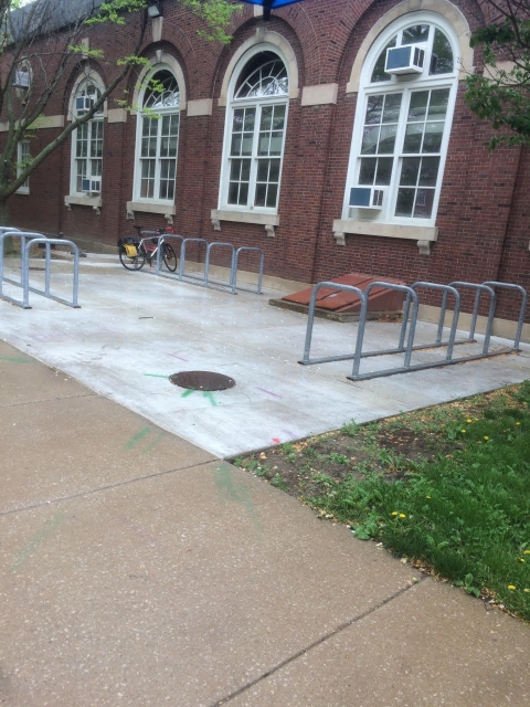 The image shows the 3 sets of bike parking U-loops outside of the armory