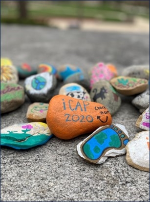 small rocks with sustainability slogans painted on them