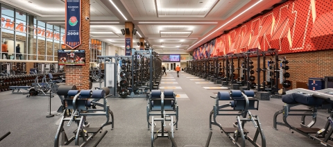 A large weights room with various types of equipment.