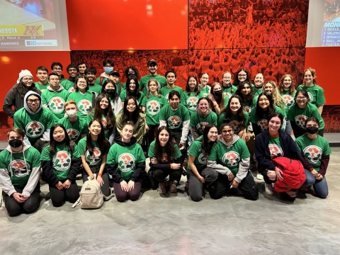 The group of roughly 50 student volunteers posing for a photo in their bright green t-shirts.