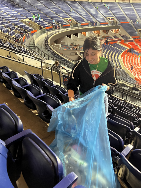 Volunteer going through the stands after the game.
